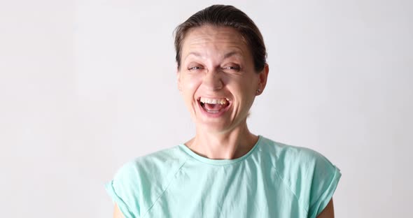 Portrait of Happy Laughing Woman Showing Doubt and Denial Gesture