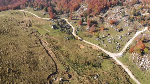 Flying over pasture in Slovenia. Aerial shot of rural roads.