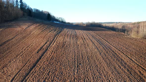 AERIAL: Plowed Farm Area on a Sunny Day in Eastern Europe