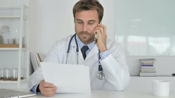 Doctor Attending Phone Call of Patient Discussing Health