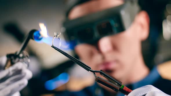 A Jeweller Uses Welding Machine While Working with a Ring.