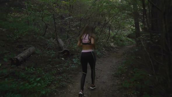Sports Brunette Girl Trail Running in the Woods, Slow Motion Footage