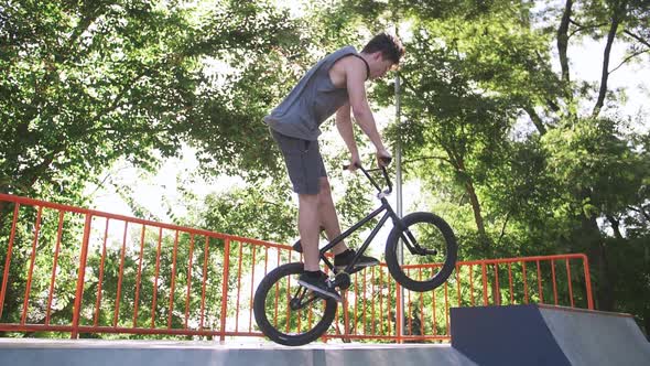 BMX Rider Doing Tricks in Cocncrete Skatepark Super Slow Motion