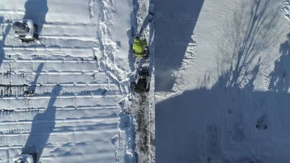 Bird's Eye View Of The People Plowing The Snow On The Roof Top Of The Building In Zakopane Town, Sou