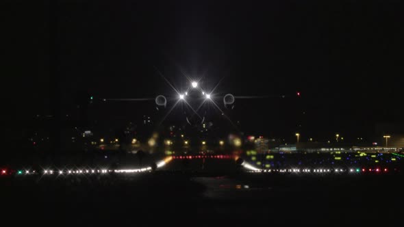 Airplane Taking Off at Night from Airport Runway