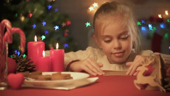 Cute Girl Preparing Envelope With Letter for Santa, Childish Belief in Miracle