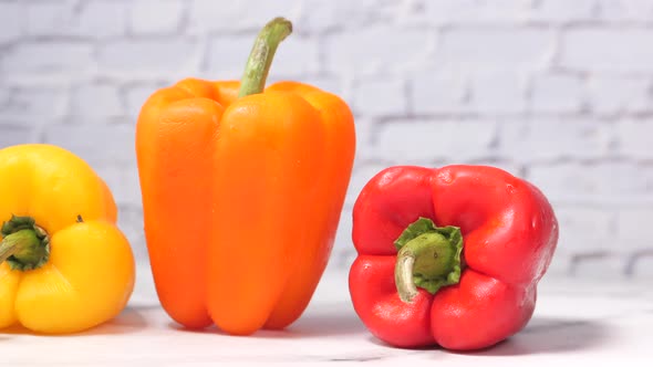 Yellow Orange and Red Capsicum on Table 