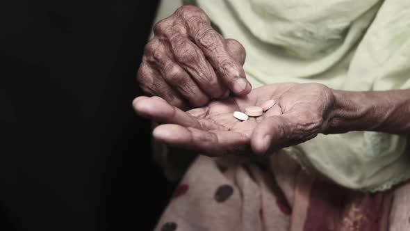 Slow Motion of Senior Women Taking Medicine in Dark