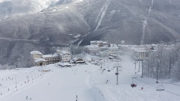 People Riding on Slope Ski and Snowboard in Mountain Resort. Aerial View