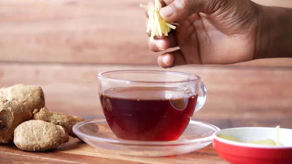 Green Tea Served with Slice of Ginger on Table