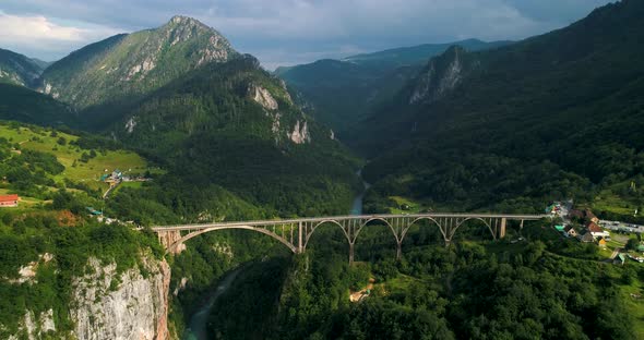 The Bridge Through River in Mountains