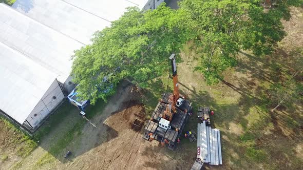 Business Project Construction Site Pile Installation Machine Ascending Drone Shot