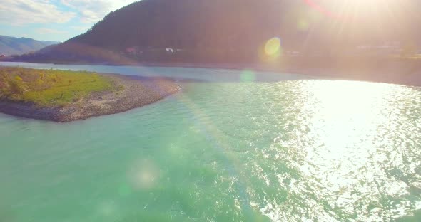 Low Altitude Flight Over Fresh Fast Mountain River with Rocks at Sunny Summer Morning.