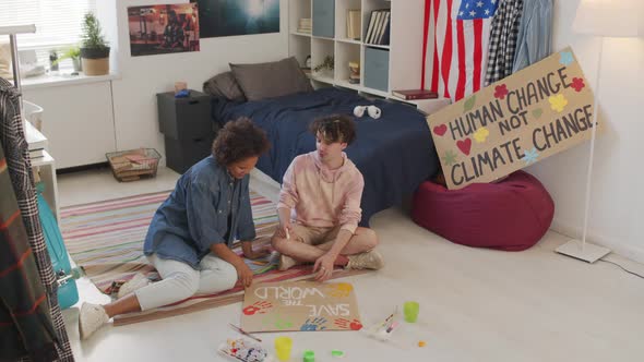 Two Friends Crafting Slogan Signs