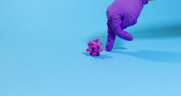 Doctor's Hand in gloves fighting pathogen cell of coronavirus. Stop motion animation.