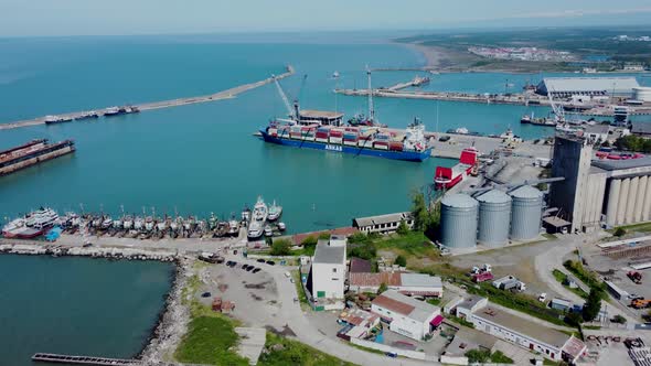 Aerial top view of cargo ship standing in the port