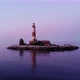 Small artificial island with old light tower, aerial shot in dusk, many birds - VideoHive Item for Sale