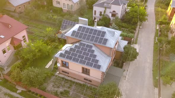 Aerial view of a private house with solar panels on roof. Photo voltaic system for renewable energy