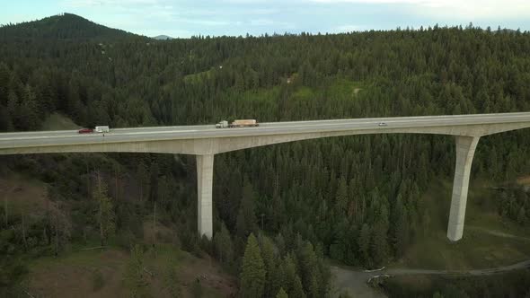 Fly Over of Arched Bridge with Traffic Passing By