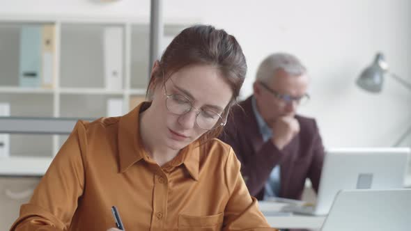 Nervous New Female Employee Performing Tasks in Office