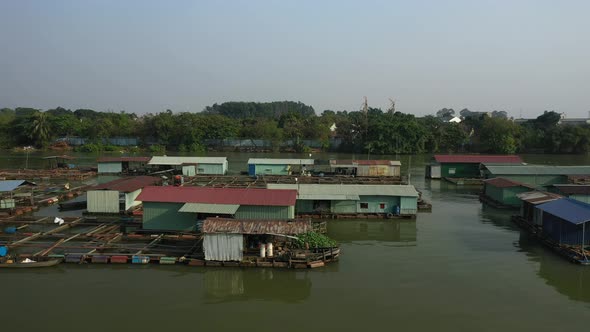 Tracking drone shot along floating fish farming community in Bien Hoa on the Dong Nai river, Vietnam