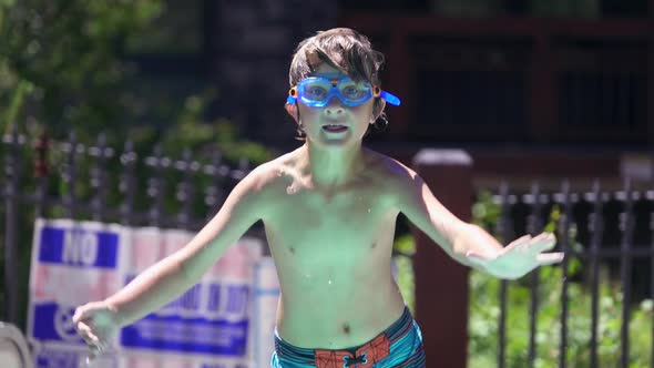 A boy plays in a pool at a hotel resort.