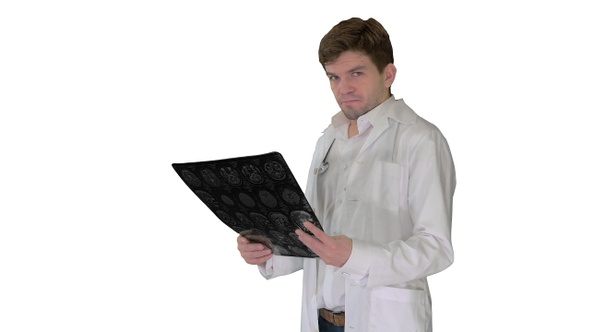 Upset male doctor looking at x-ray MRI image and looking