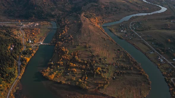 Panoramic Aerial Drone View Flight Over Autumn Countryside Village Along Curving River and Road in