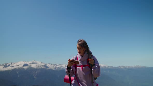 Tourist Woman is Orienting By Electronic Map in Mobile Phone in Mountains