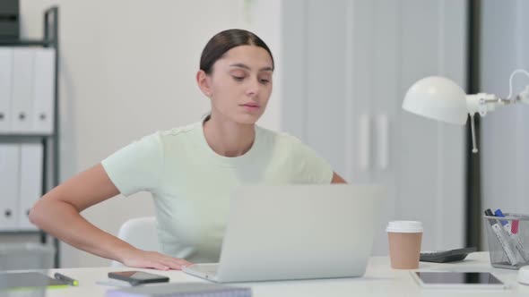 Young Latin Woman Leaving Office After Working on Laptop