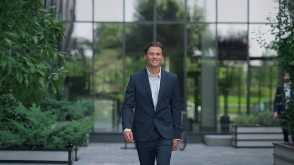 Confident Businessman Walking Downtown Complex in Suit