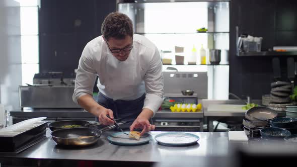 Chef Serving Cooked Fish on Plates