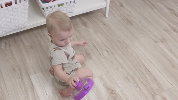 Cute Small Child Playing with Toys 1 Year Old Baby Boy Holding Holding Learning Bot Toy