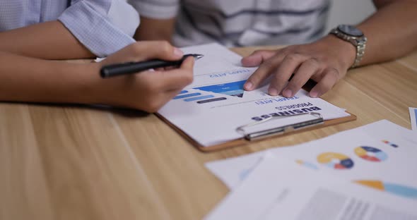 Close up docment of Asian young business people meeting in home office