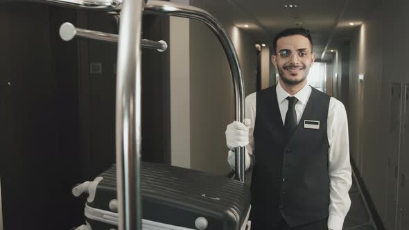 Portrait of Cheerful Bellboy in Hotel