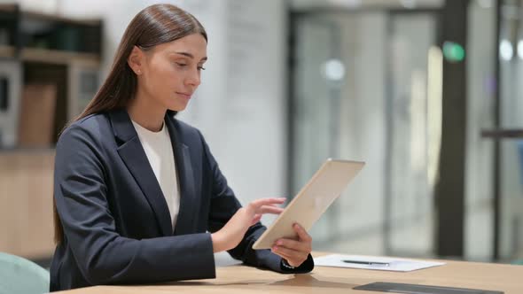 Businesswoman Celebrating Success on Tablet