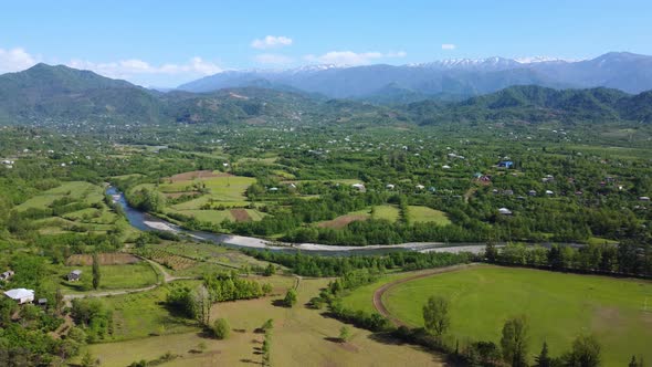 River Valley And Snowy Mountains In Summer