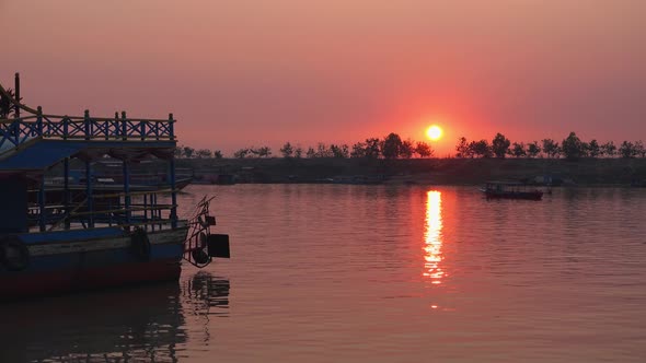 Time lapse of beautiful Orange Sun Set in the Background Over The Horizon Of the Far Shore of the La