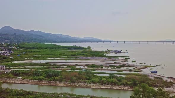 A dynamic aerial footage accross the lake of the fishing village in Lau Fau Shan in the New Territor