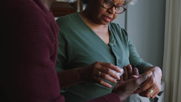 A senior african american couple spending time together at home social distancing in quarantine.