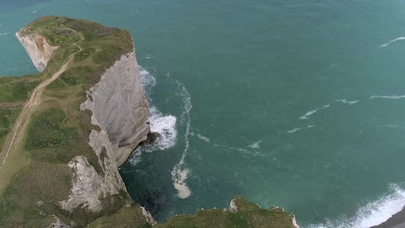 Waves at white cliffs rock formation coastline, Etretat. Aerial