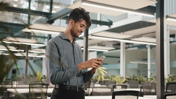 Smiling Happy Millennial Arabian Man Professional Hispanic Worker Businessman Guy Hold Smartphone