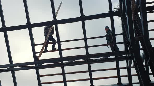 Silhouette of Roof Installers