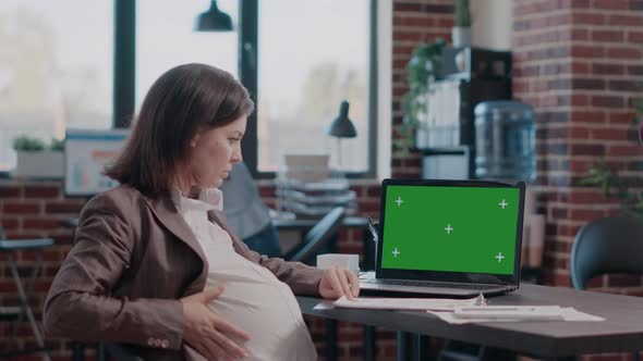 Pregnant Woman Having Laptop with Horizontal Green Screen