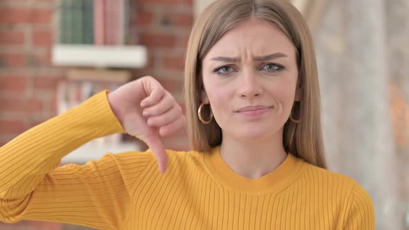 Portrait of Beautiful Young Woman Doing Thumbs Down