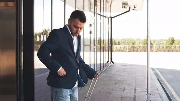 Elegant businessman in airport. Young mail entrepreneur in formalwear.