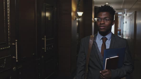 African American Businessman Going through Corridor of Office Center