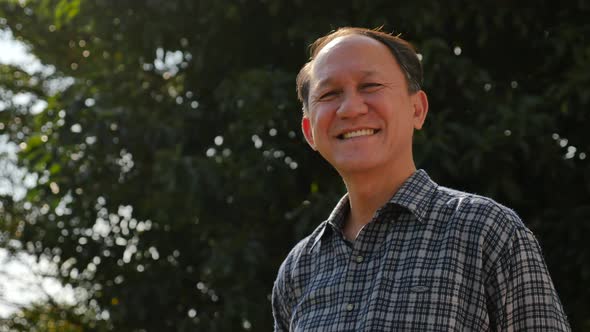 Close Up Of Happy Asian Old Man With Nature Background