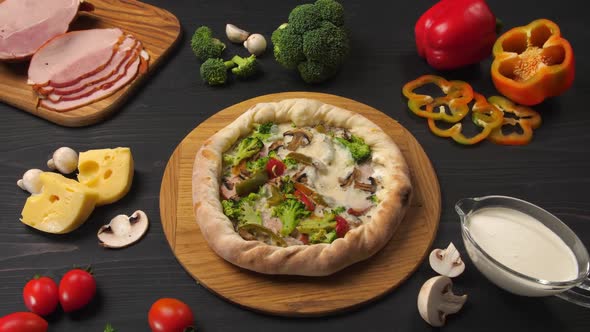 Presentation of Pizza on a Dark Brown Table with Its Ingredients