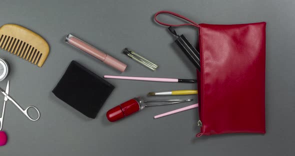 Women's Cosmetics and Makeup Tools Fly Into an Open Cosmetic Bag alt